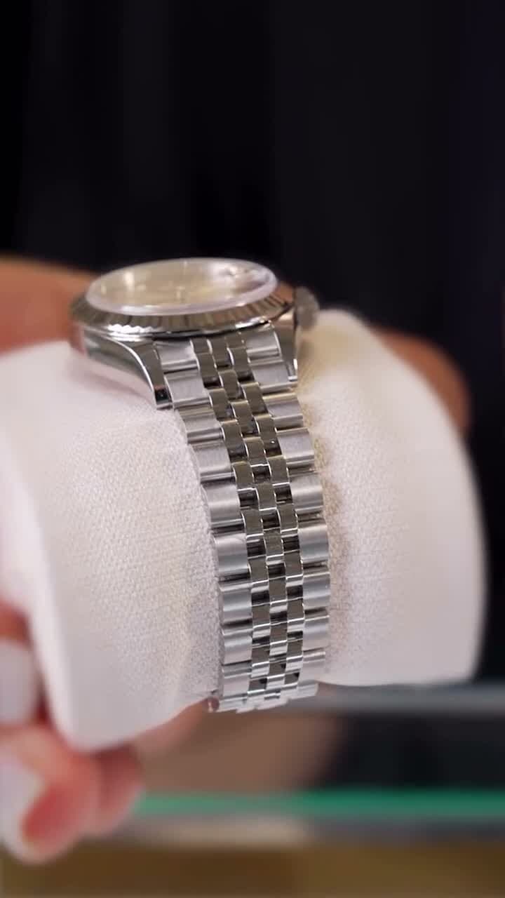 A Rolex Datejust on the jubilee bracelet, held in hand