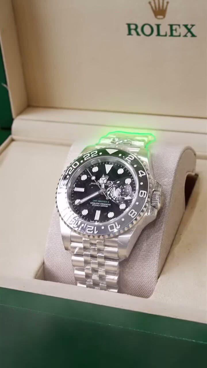 A Rolex GMT in its green Rolex box